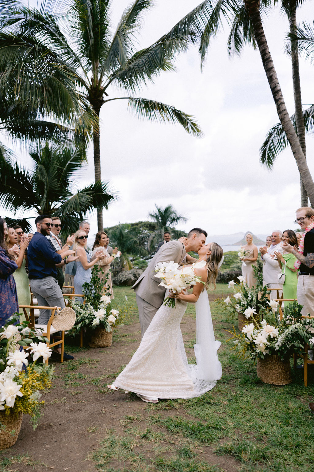 bride and groom kiss at wedding ceremony in hawaii