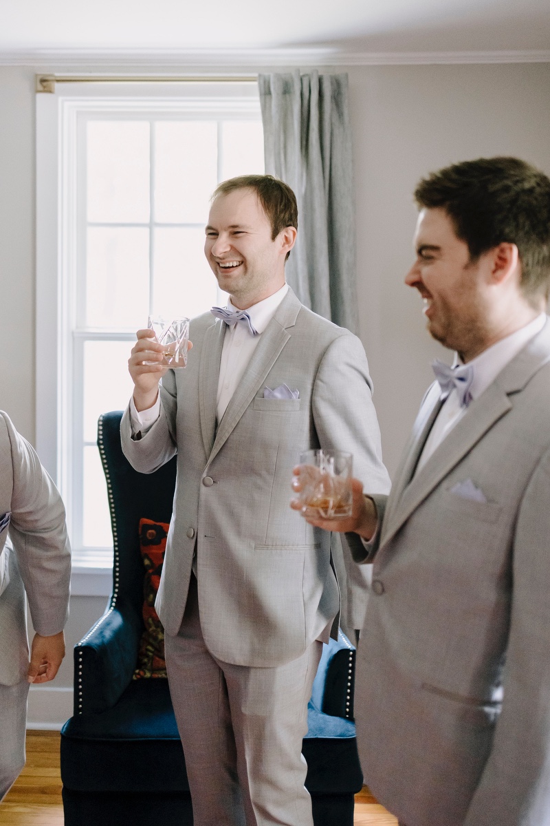 groom in gray suit with lavender tie