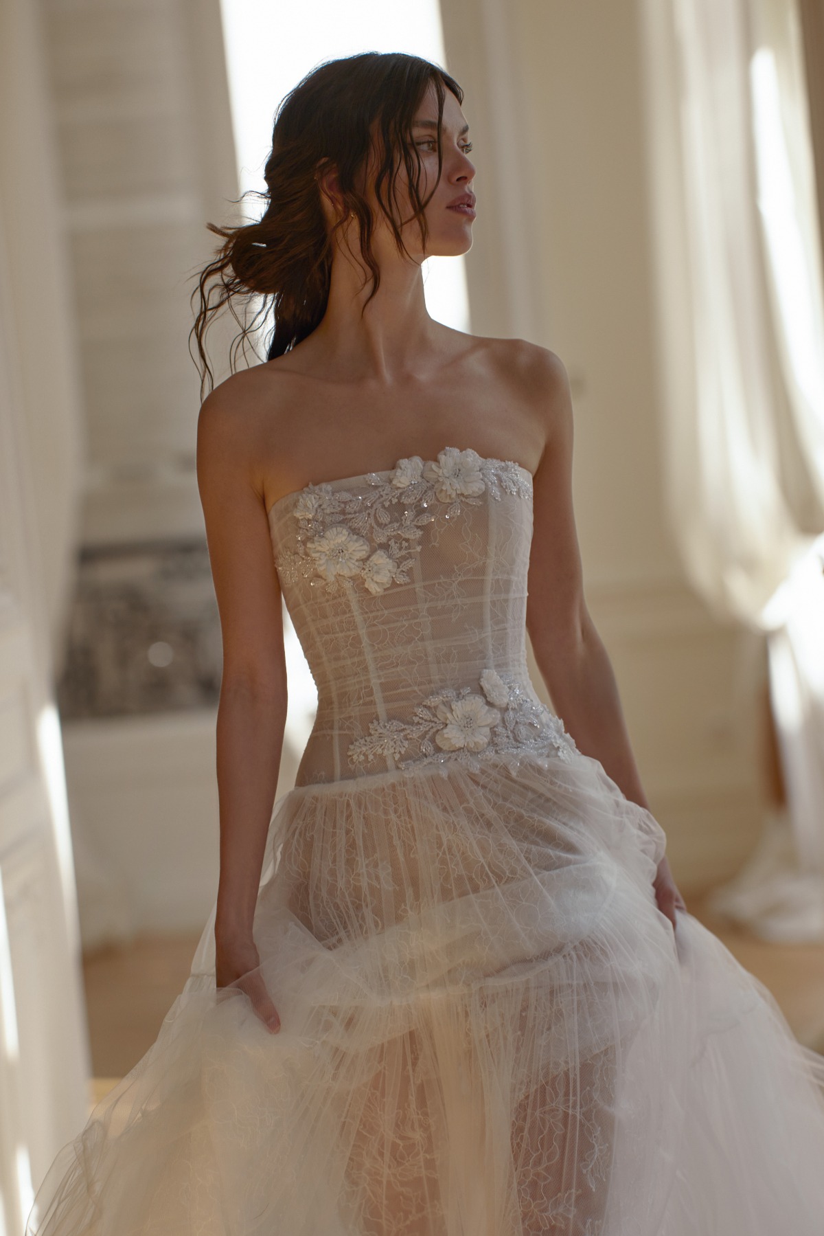 bride wearing strapless wedding gown with 3d floral applique and structured bodice