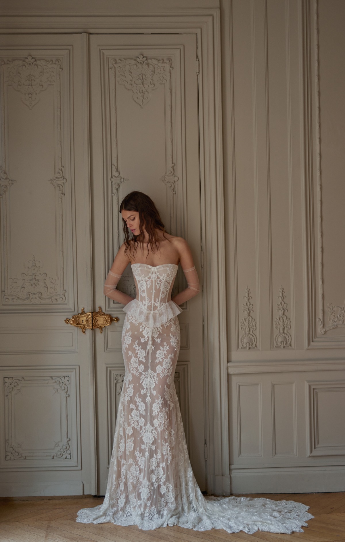 bride wearing fitted floral lace wedding dress and sheer gloves