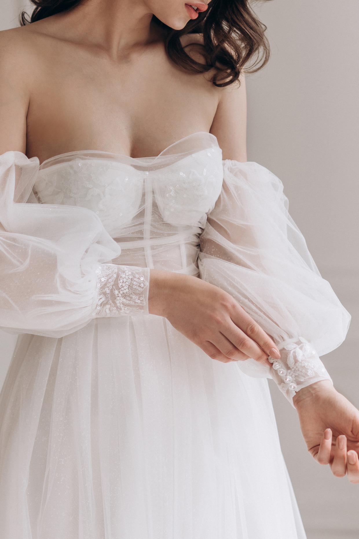 bride wearing long sleeve tulle dress