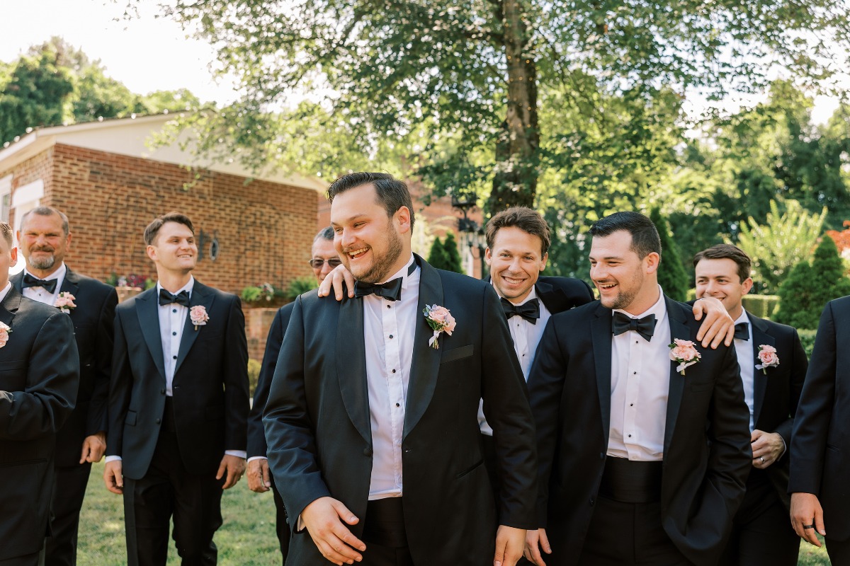 black suit with pink boutonniere