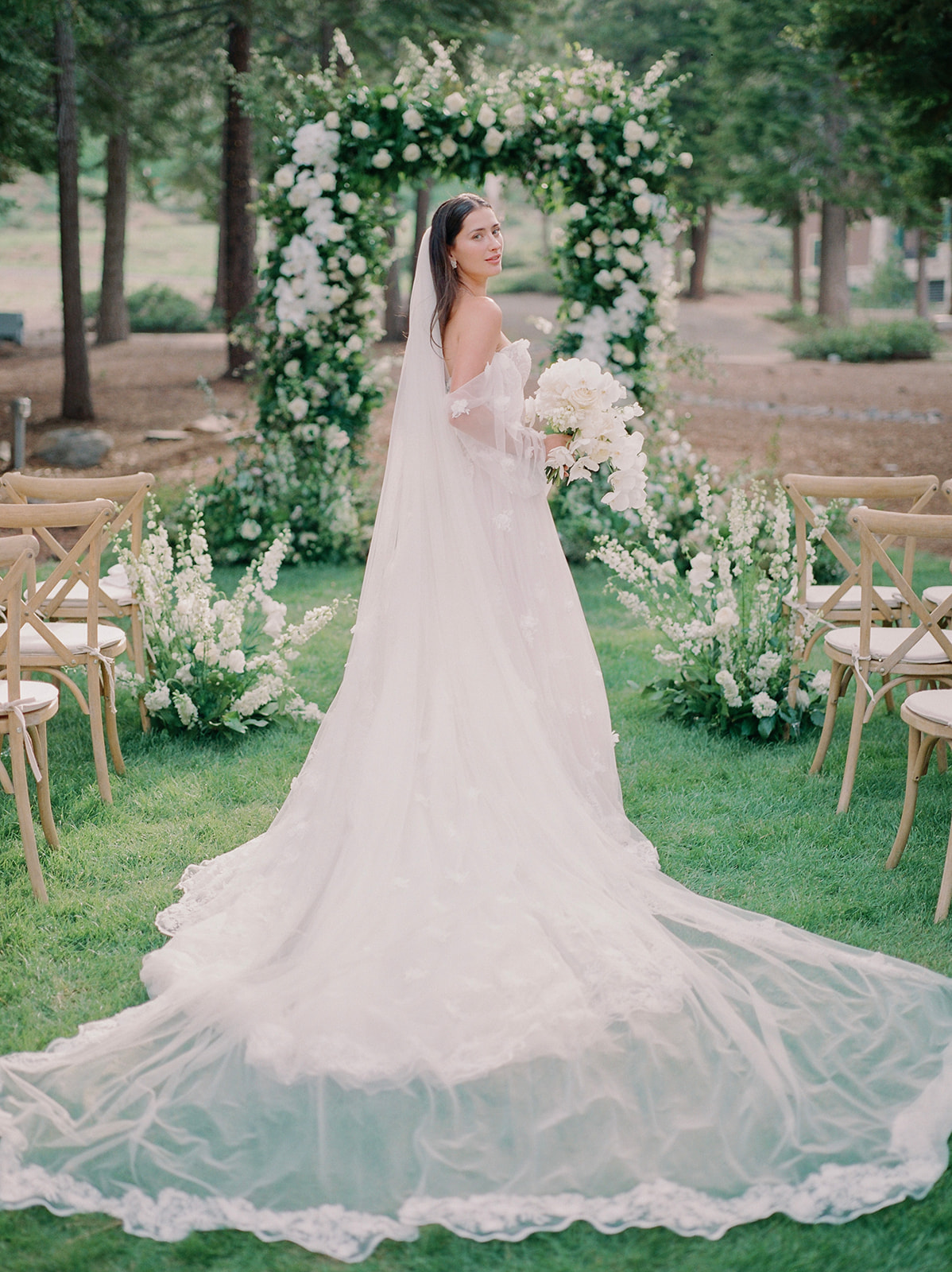 bride posing on woodland aisle