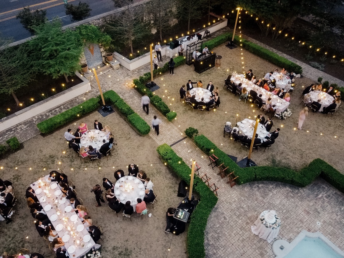 overhead shot of wedding reception with round tables and string lights