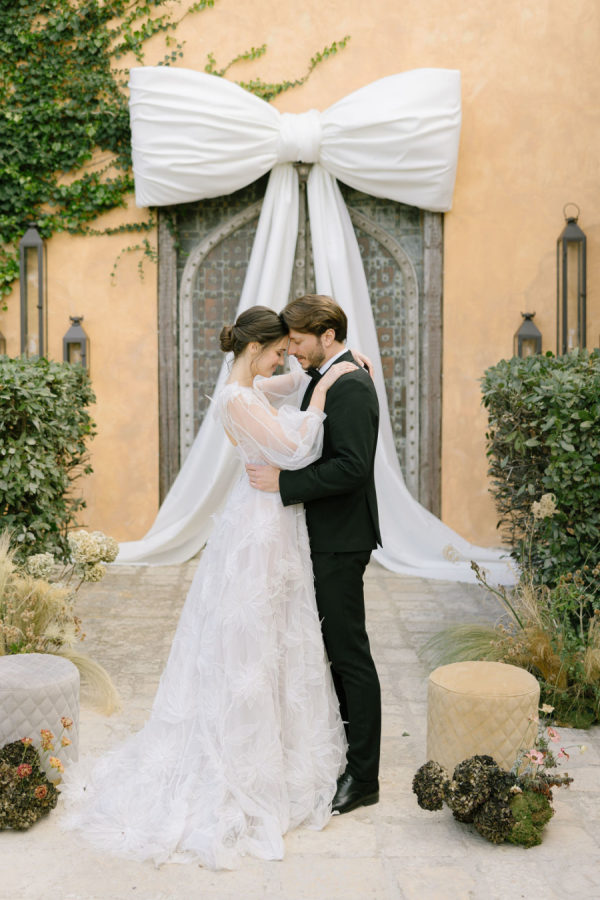A Mediterranean Wedding in Greece Defined by Sculptural Bows, Dreamy Florals, and Candlelight